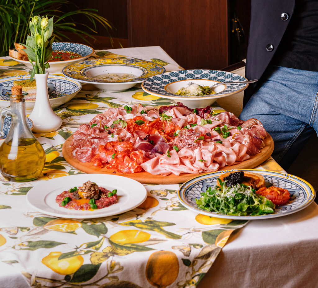 Man enjoying a feast of italian dishes -